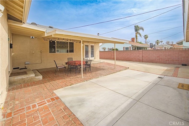 view of patio / terrace with french doors and fence