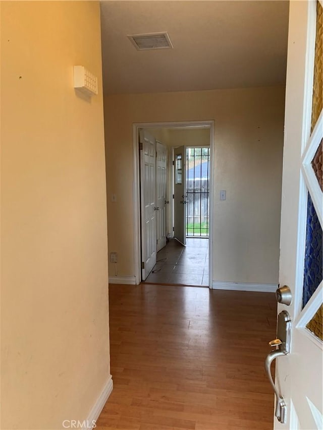 interior space featuring visible vents, baseboards, and wood finished floors