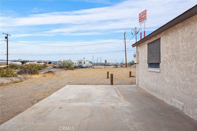 view of yard featuring a patio area and visible vents