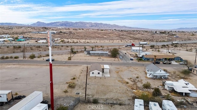 aerial view featuring a desert view and a mountain view