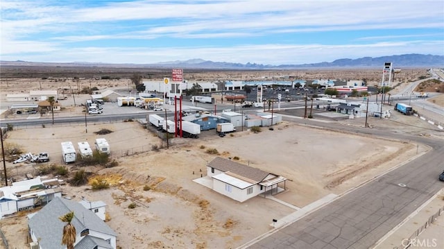 birds eye view of property featuring a desert view and a mountain view