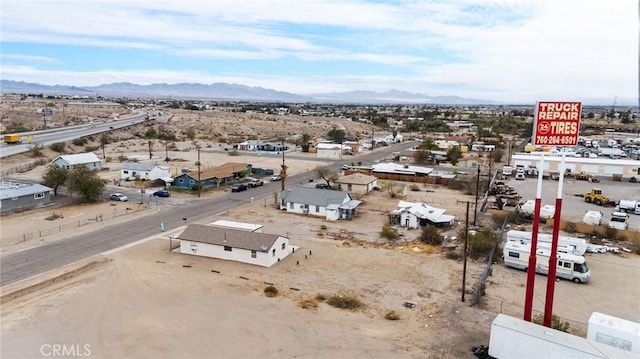 birds eye view of property featuring a mountain view