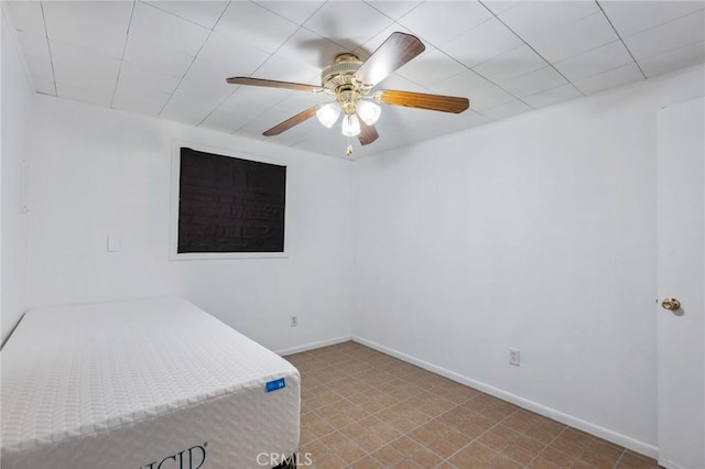 bedroom with a ceiling fan and baseboards