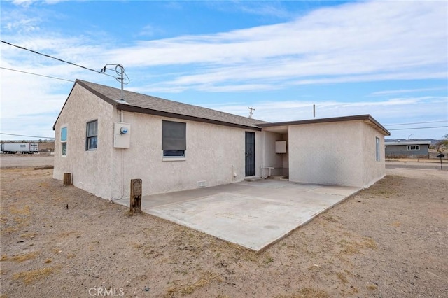 rear view of house with a patio, crawl space, and stucco siding