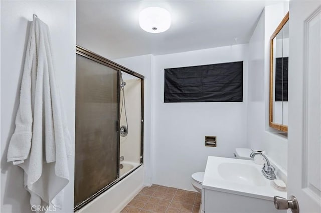 bathroom with enclosed tub / shower combo, vanity, toilet, and tile patterned floors