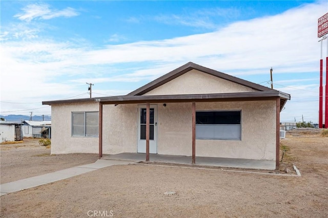 view of front of home with a patio and stucco siding