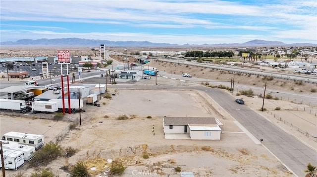 drone / aerial view featuring a desert view and a mountain view