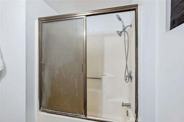 full bath featuring a shower with door