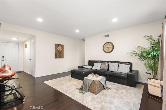 living area with dark wood-style floors, recessed lighting, visible vents, and baseboards