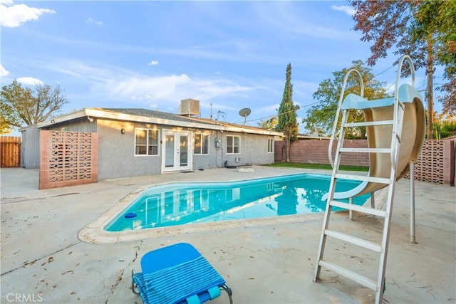 view of swimming pool featuring a patio, french doors, a fenced backyard, and a fenced in pool