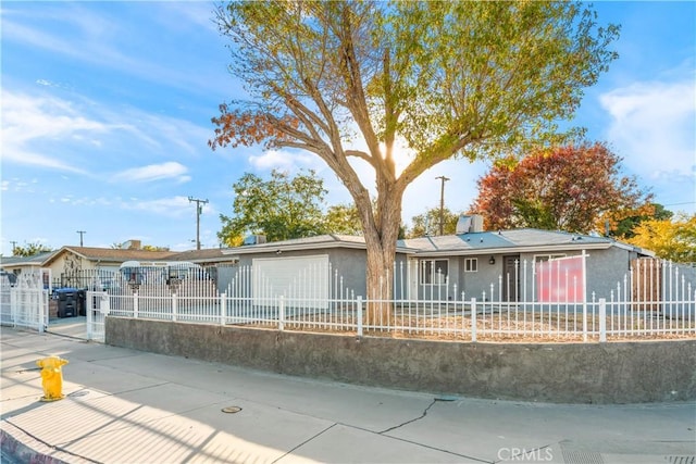 ranch-style house with a fenced front yard and stucco siding