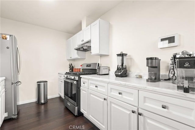 kitchen featuring under cabinet range hood, white cabinetry, appliances with stainless steel finishes, and dark wood-type flooring