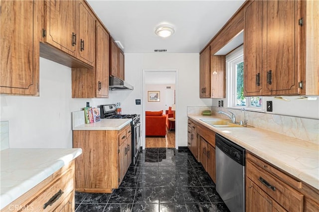 kitchen featuring appliances with stainless steel finishes, extractor fan, a sink, and brown cabinetry