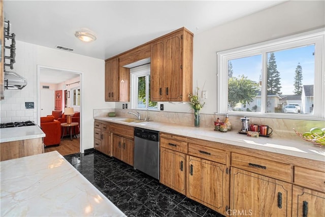 kitchen with a sink, visible vents, light countertops, stainless steel dishwasher, and brown cabinets