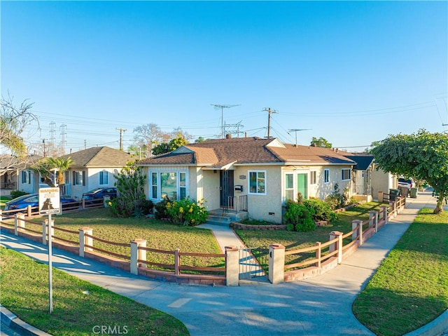 single story home featuring a fenced front yard, a shingled roof, a front lawn, and stucco siding