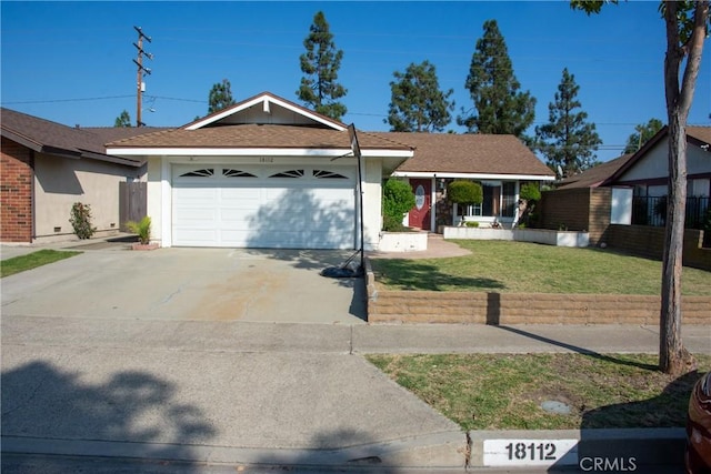 ranch-style home with a garage, driveway, fence, a front yard, and stucco siding