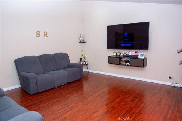 living area featuring wood finished floors and baseboards