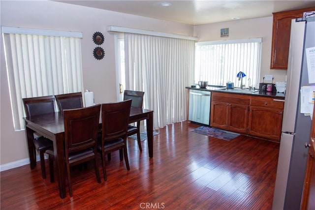 dining room with dark wood-style floors and plenty of natural light