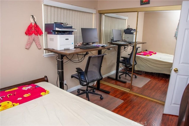 bedroom featuring wood finished floors and baseboards