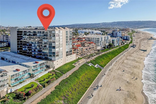 bird's eye view with a water view, a view of city, and a beach view