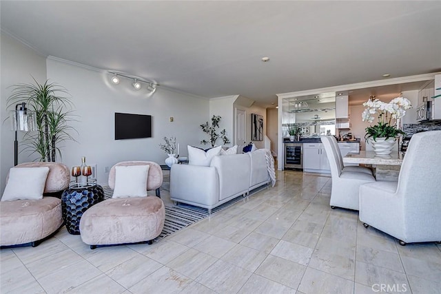 living area featuring ornamental molding and wine cooler