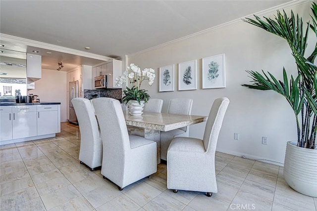 dining space with crown molding