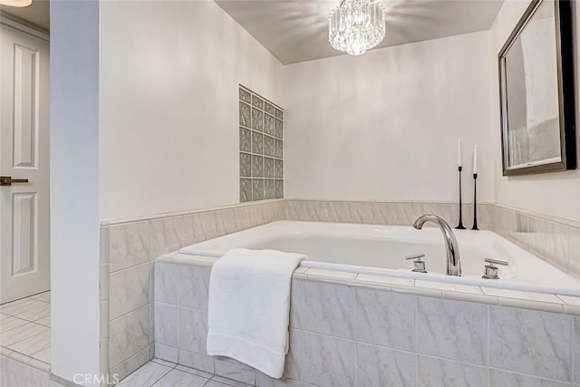 full bath featuring a chandelier and a bath