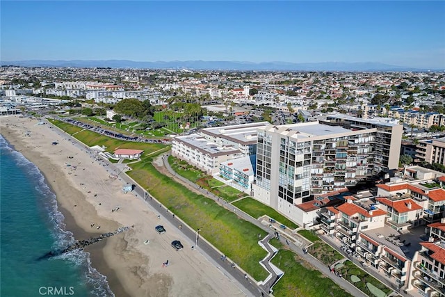 birds eye view of property featuring a water view, a view of the beach, and a city view