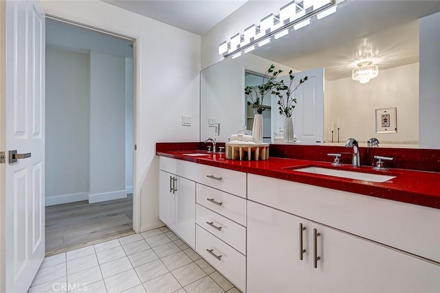 bathroom featuring double vanity, a sink, and tile patterned floors