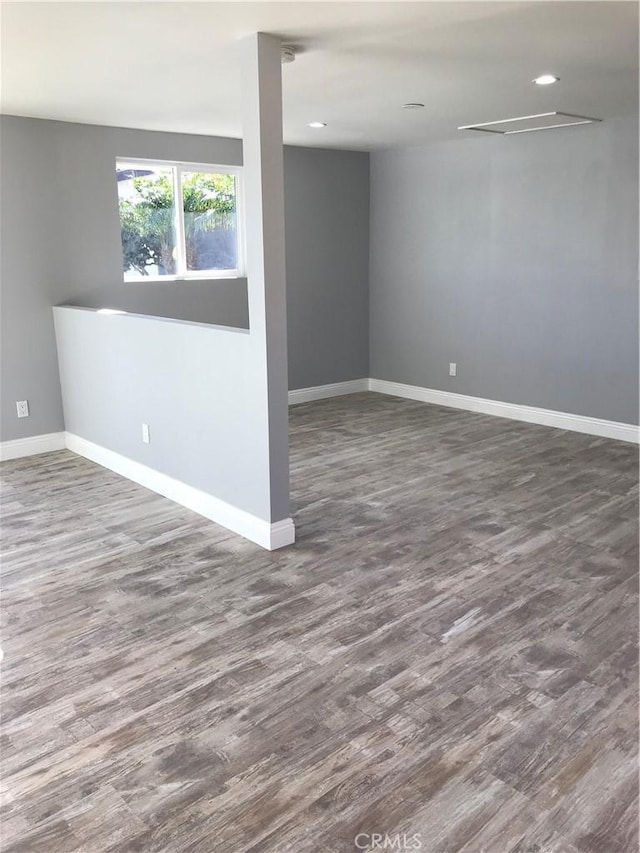 unfurnished room featuring dark wood-style flooring, recessed lighting, and baseboards