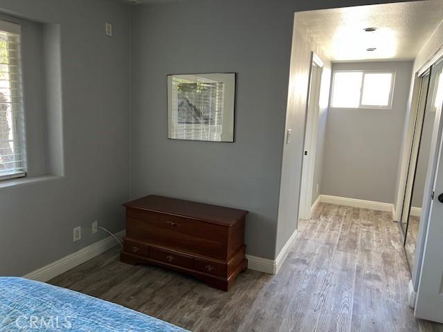 bedroom featuring wood finished floors and baseboards