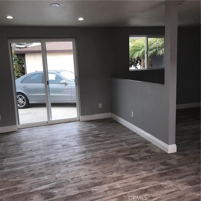 unfurnished room featuring dark wood-style floors, recessed lighting, and baseboards