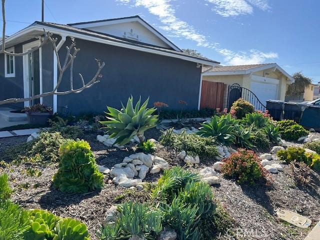 view of property exterior featuring fence and stucco siding