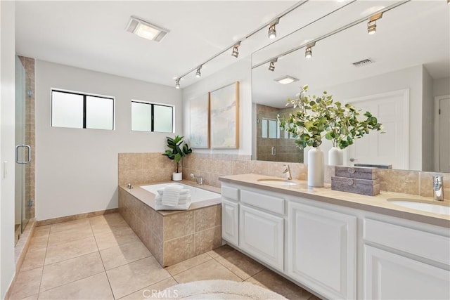 full bath with a shower stall, a sink, visible vents, and tile patterned floors