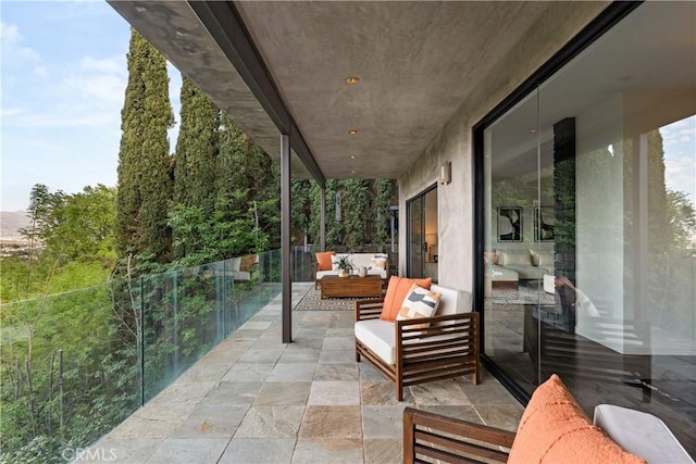 view of patio featuring a balcony and outdoor lounge area