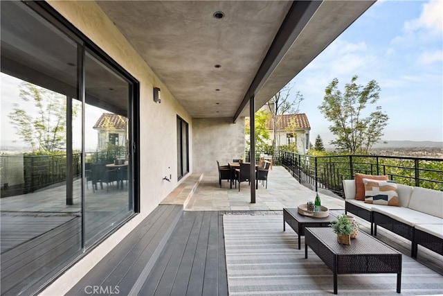 wooden terrace featuring outdoor dining area and an outdoor hangout area