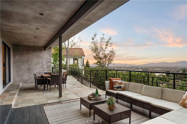 deck at dusk featuring an outdoor living space