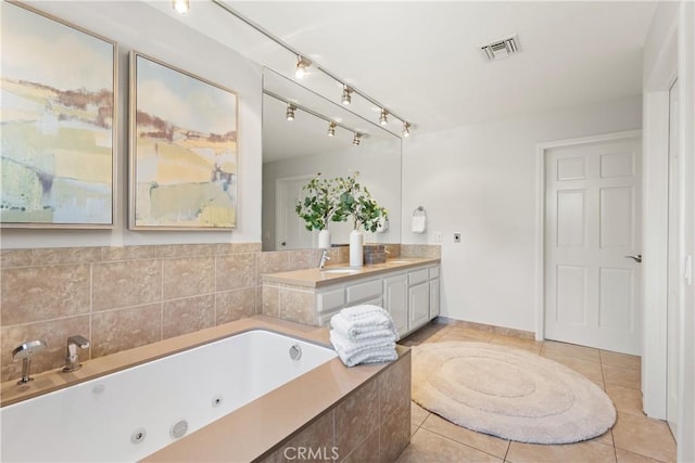 full bathroom with double vanity, visible vents, a sink, tile patterned flooring, and a tub with jets