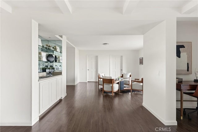 dining room featuring baseboards, dark wood-style flooring, and beamed ceiling