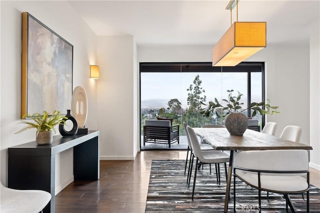 dining room with dark wood-type flooring and baseboards