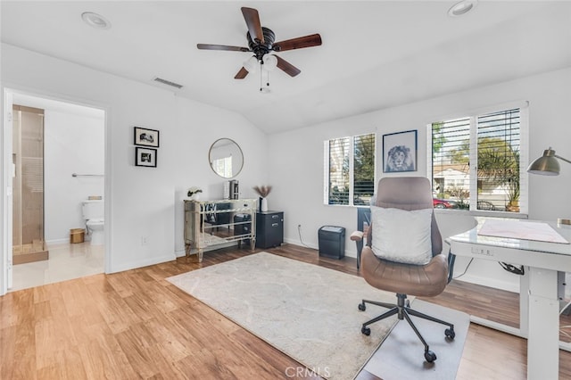 office area with visible vents, vaulted ceiling, baseboards, and wood finished floors