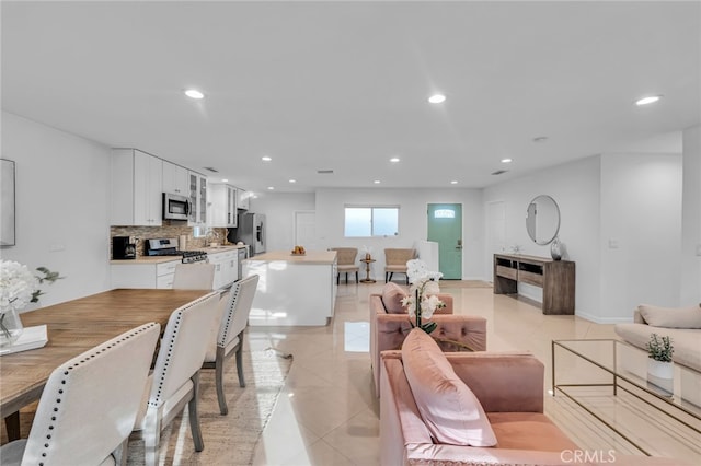 living room with light tile patterned floors and recessed lighting