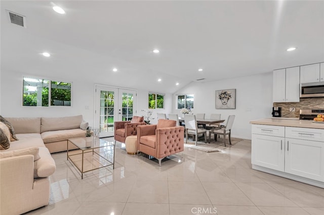 living area featuring french doors, visible vents, and recessed lighting