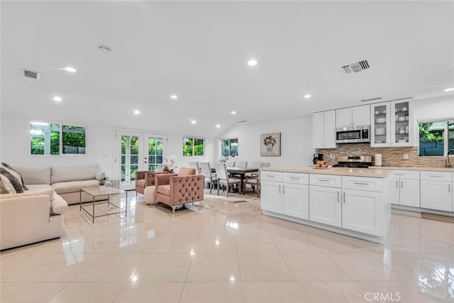 living room with recessed lighting, french doors, visible vents, and light tile patterned floors