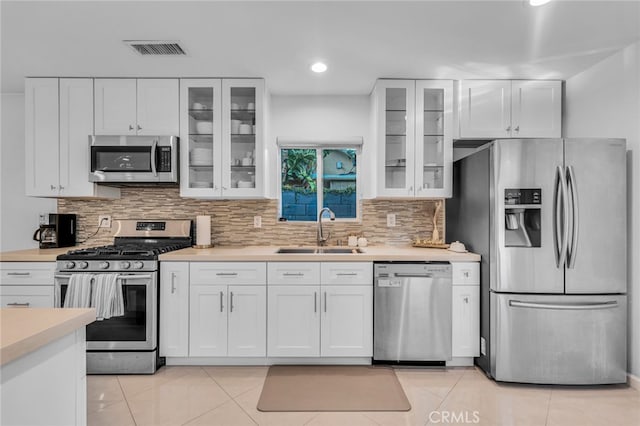 kitchen featuring a sink, visible vents, white cabinetry, light countertops, and appliances with stainless steel finishes