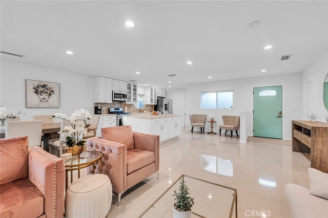 living room with visible vents and recessed lighting