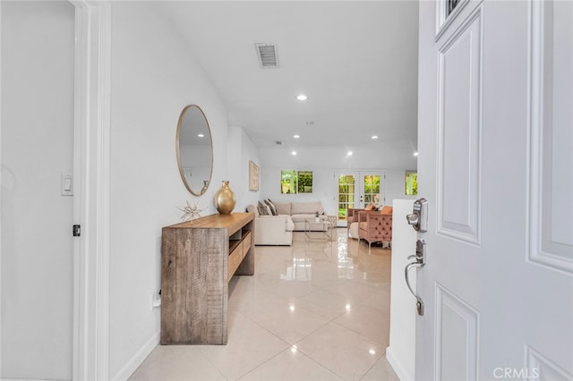 foyer with french doors, light tile patterned floors, recessed lighting, visible vents, and baseboards