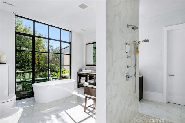 full bathroom featuring marble finish floor, a marble finish shower, visible vents, and vanity