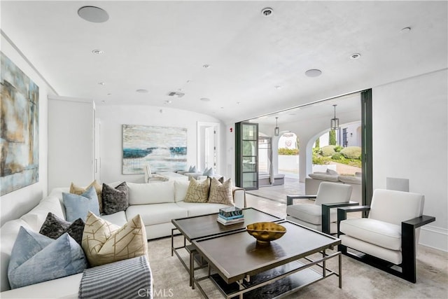 living room featuring lofted ceiling