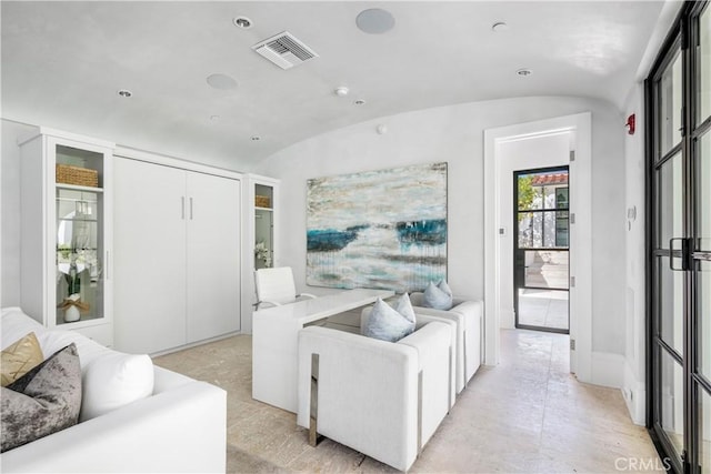 living area with lofted ceiling and visible vents